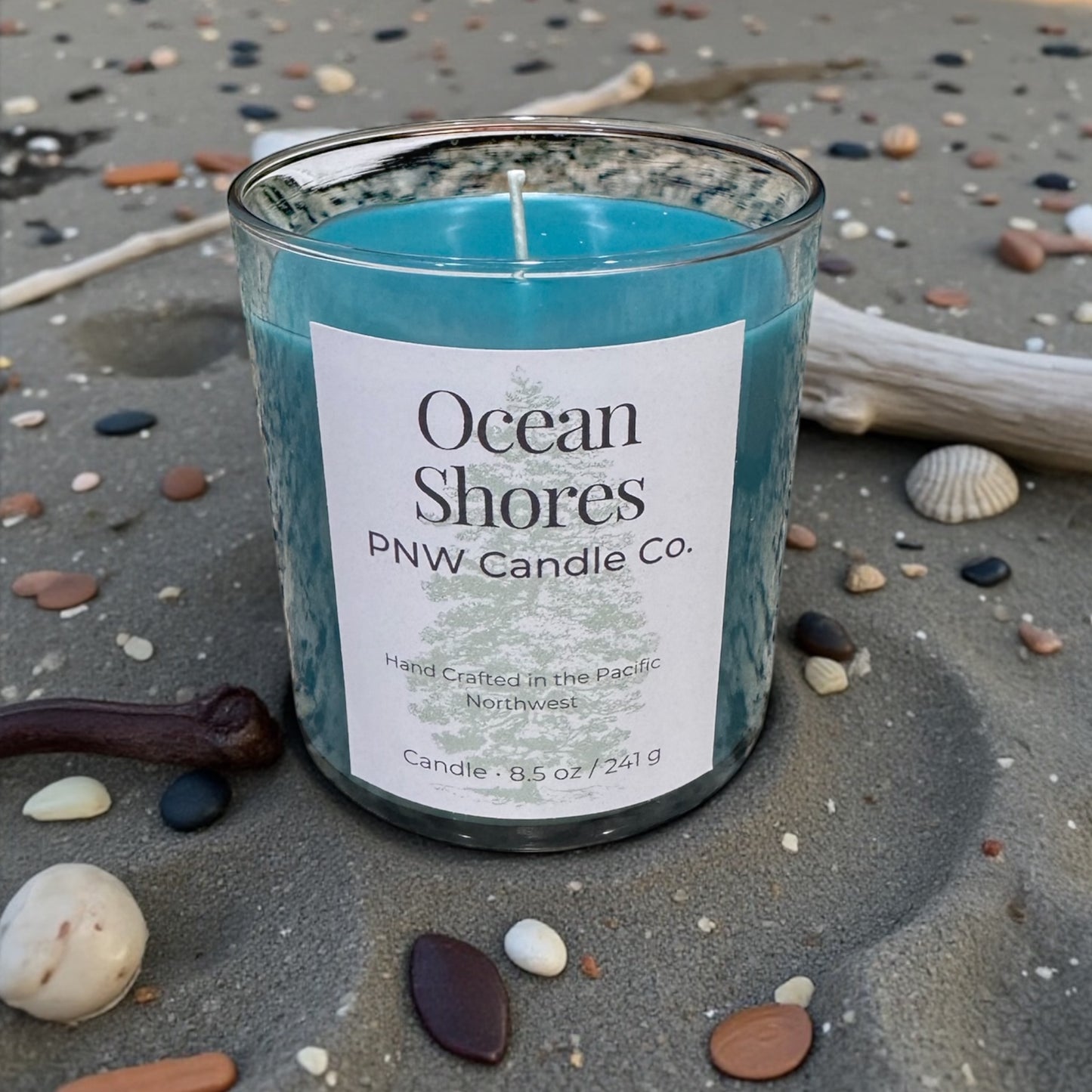 PNW Candle Co Ocean Shores scented candle with a beige ceramic jar and minimalist label, perfect for relaxing home ambiance.