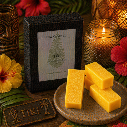 PNW Candle Co Tiki Wax Melt tart with tropical tiki design, vibrant colors, and wax texture in a close-up view.