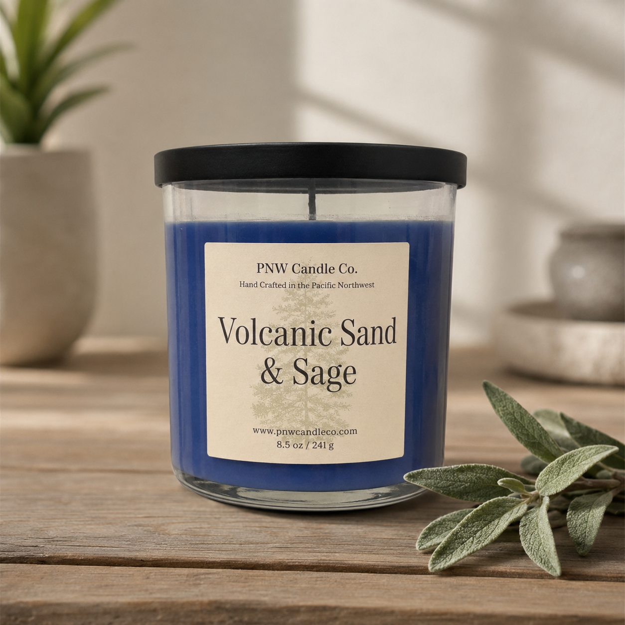 PNW Candle Co volcanic sand and sage scented candle in a glass jar with a wooden lid, showcasing its natural earthy design.