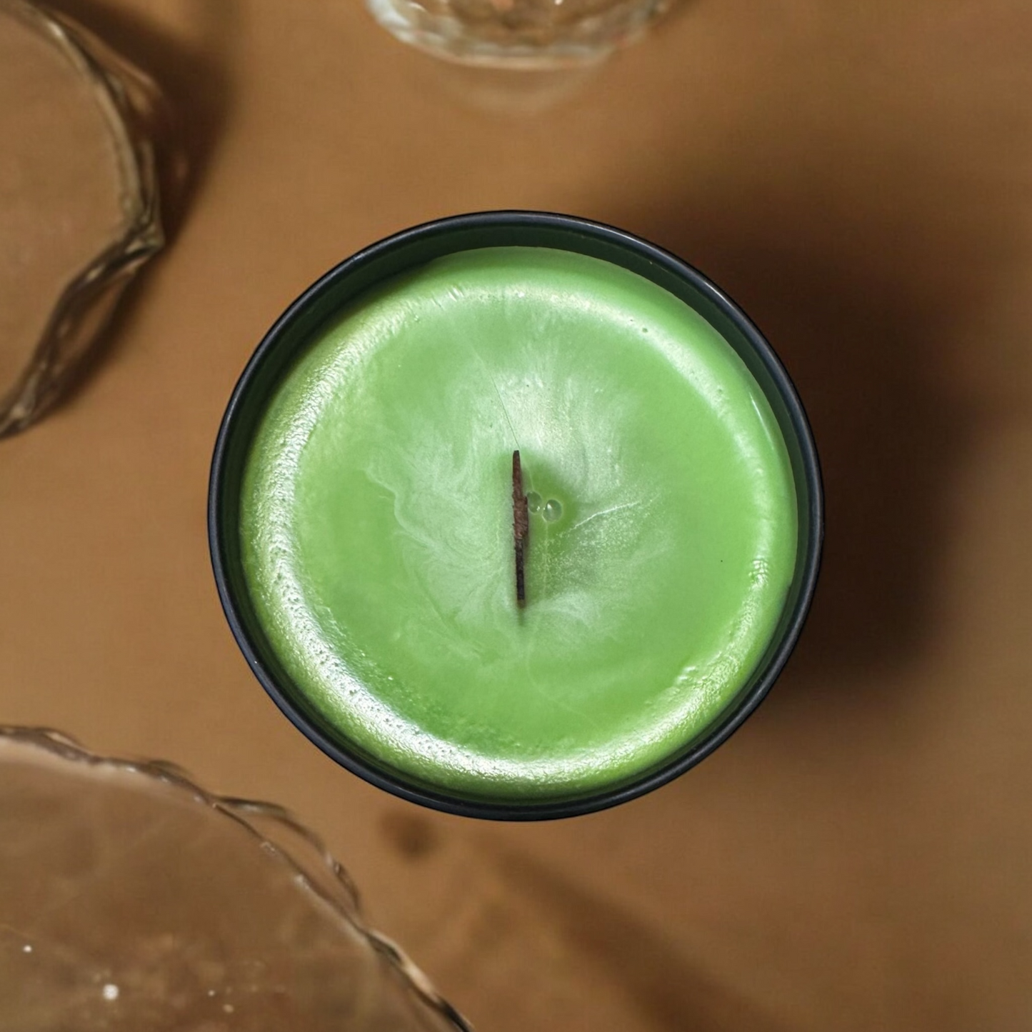 Pear Prosecco scented candle from PNW Candle Co with a clear glass jar and a lit wick, showcasing a warm, inviting glow.