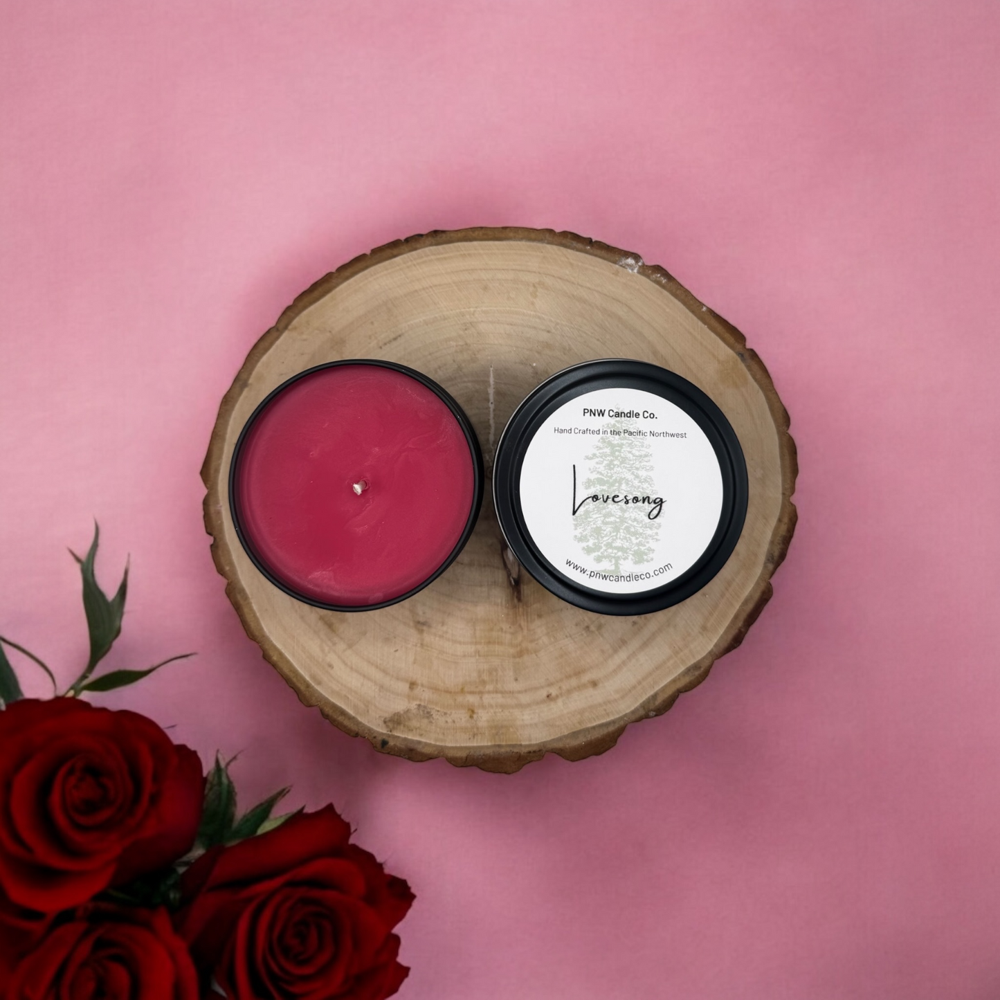 PNW Candle Co LoveSong scented candle in a jar, with a lit wick and soft glow, showcasing aromatic wax and decorative label.
