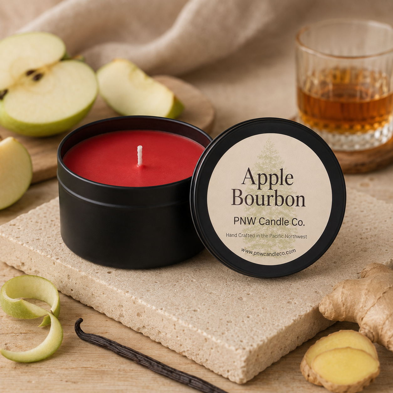 Apple Bourbon scented candle by PNW Candle Co. with red wax, green apples, ginger, vanilla, lime peel, and bourbon.