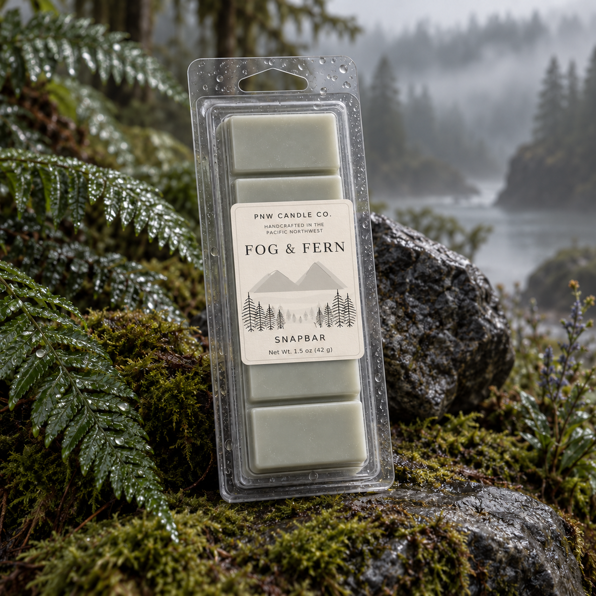 Fog & Fern 1.5 oz snapbar wax melt in pale fogged sage with PNW Candle Co. label, among rain-wet ferns, moss, stone, and Pacific Northwest mist.