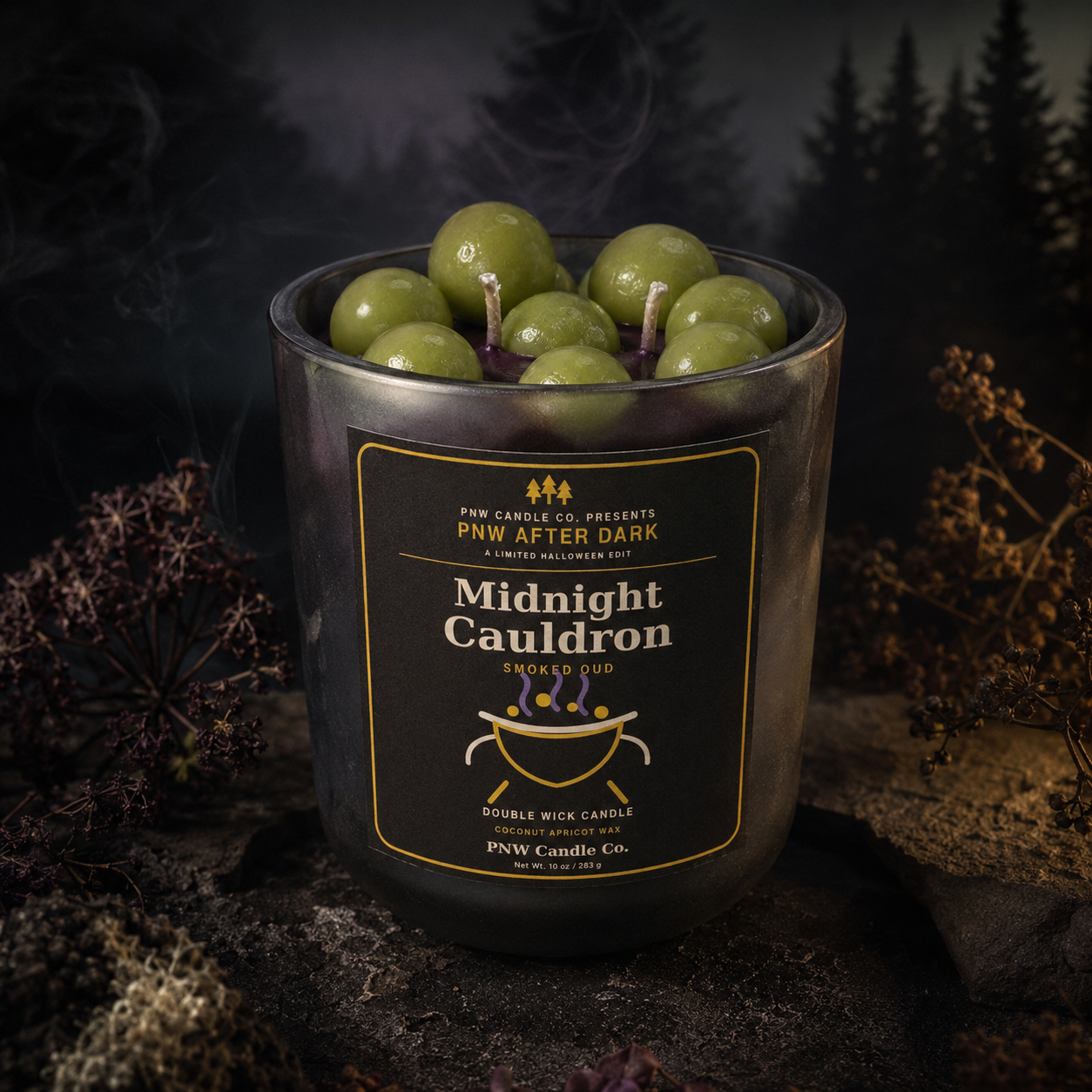 Midnight Cauldron double-wick Smoked Oud candle with green bubble wax embeds in a black tumbler