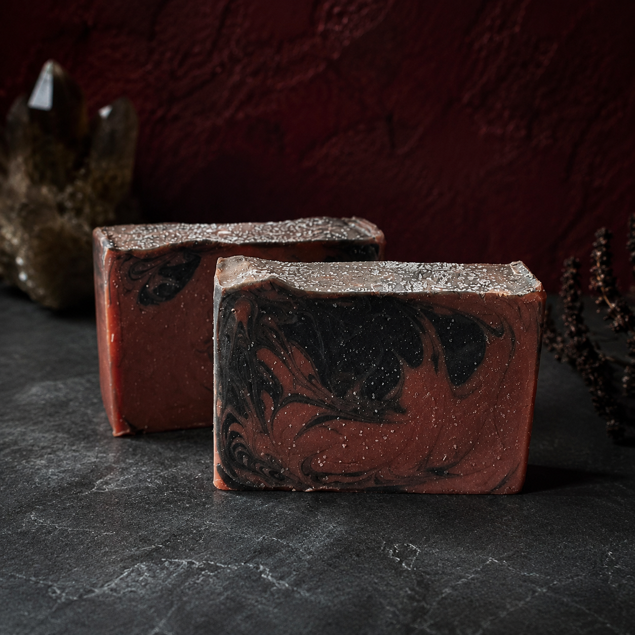 The Vampyre handcrafted cold process soap with an oxblood-red base, charcoal-black swirls, and a silver-dusted top